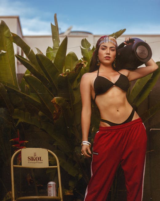 Anitta se Irrita com Fã após Pergunta sobre Shakira: “Burro” Confident woman in swimwear holding a portable speaker amidst tropical plants. — Rish Agarwal