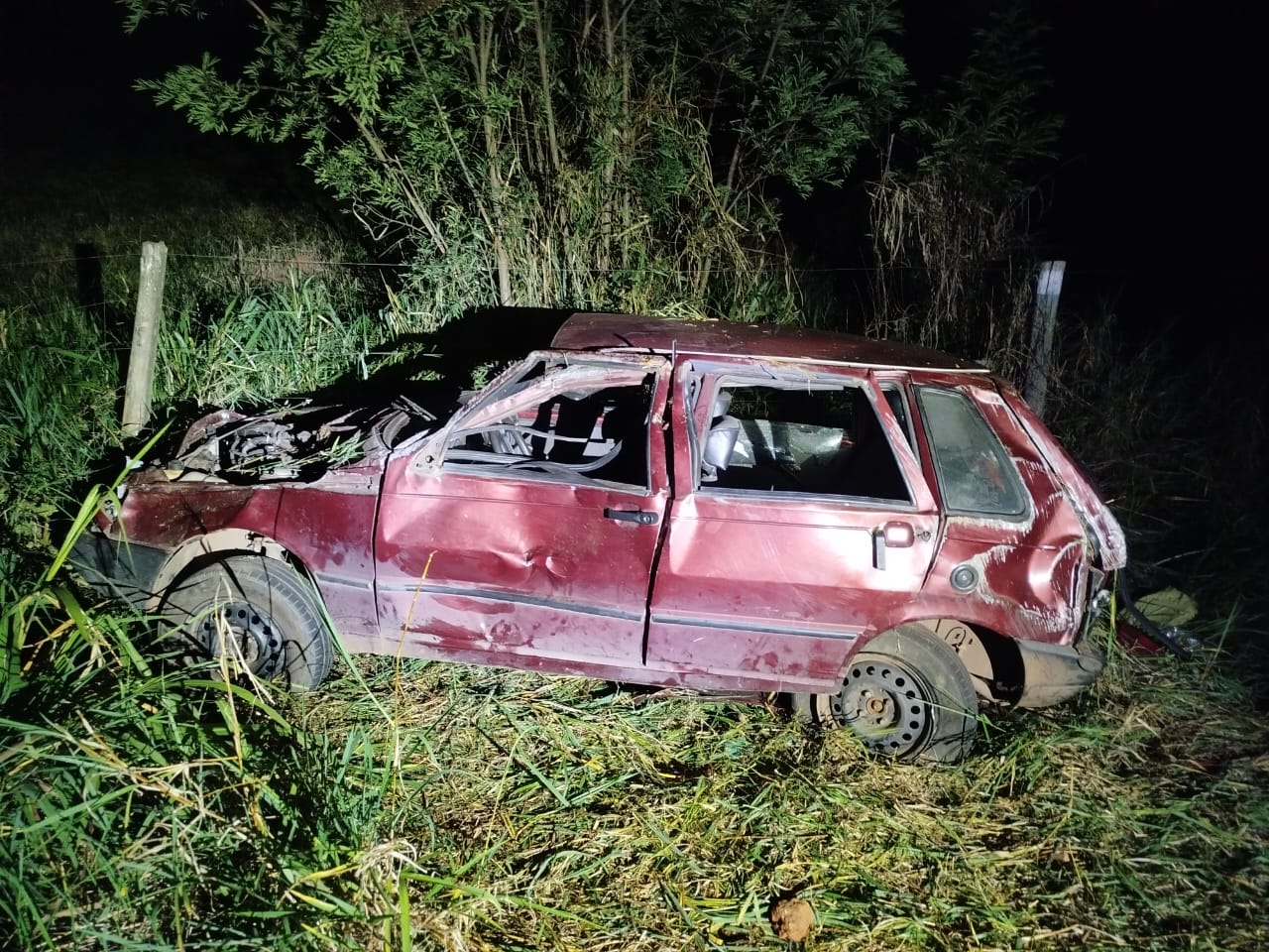 Três pessoas ficam feridas após Fiat Uno capotar na BR-352 em Onça do Pitangui